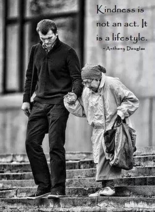 young man helping an elderly woman cross the street with kindness