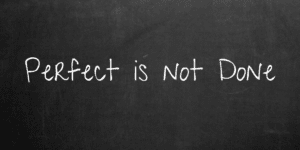 Perfect is not done written on a blackboard