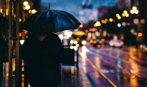 adult walking in the rain at night in the city-fighting hate