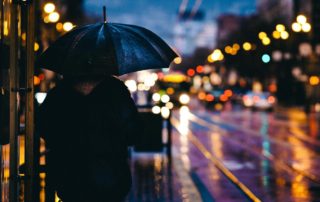 adult walking in the rain at night in the city-fighting hate
