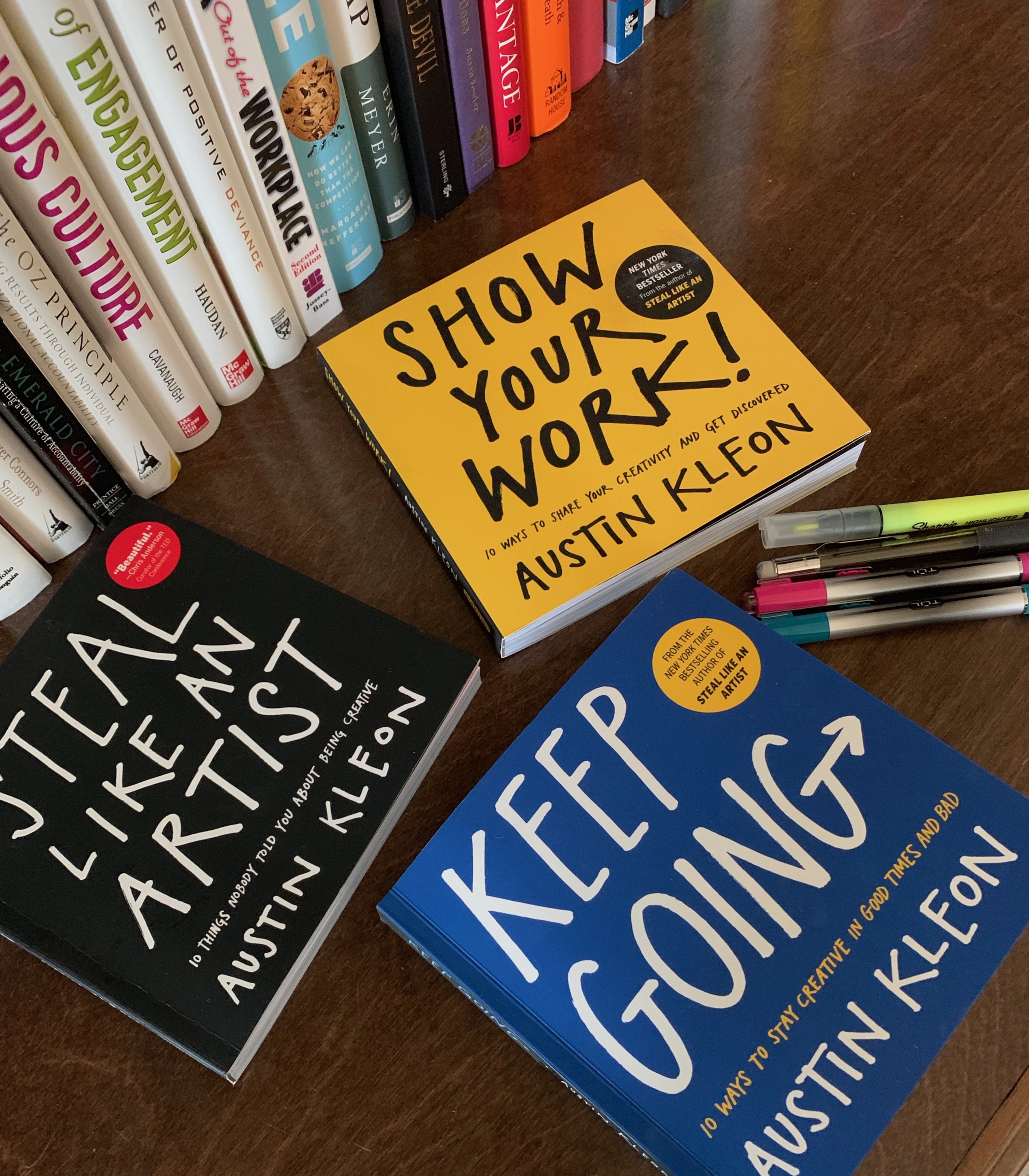 three books by Austin Kleon on a desk