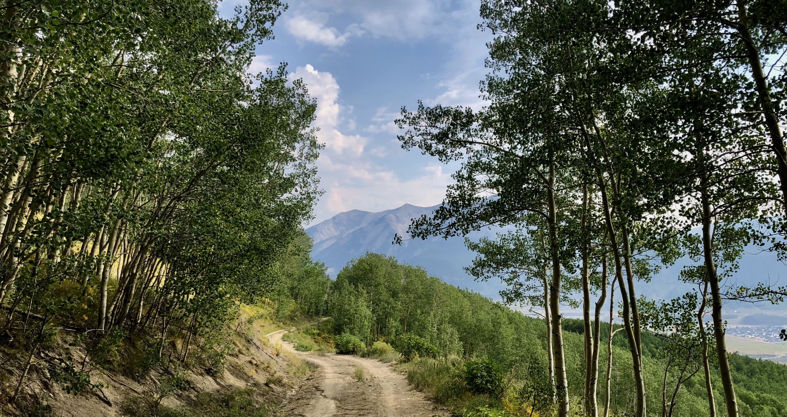 a wilderness path with the mountains in the background-joy