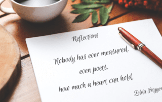 Top of desk holding a sheet of paper with a quote-what a heart can hold