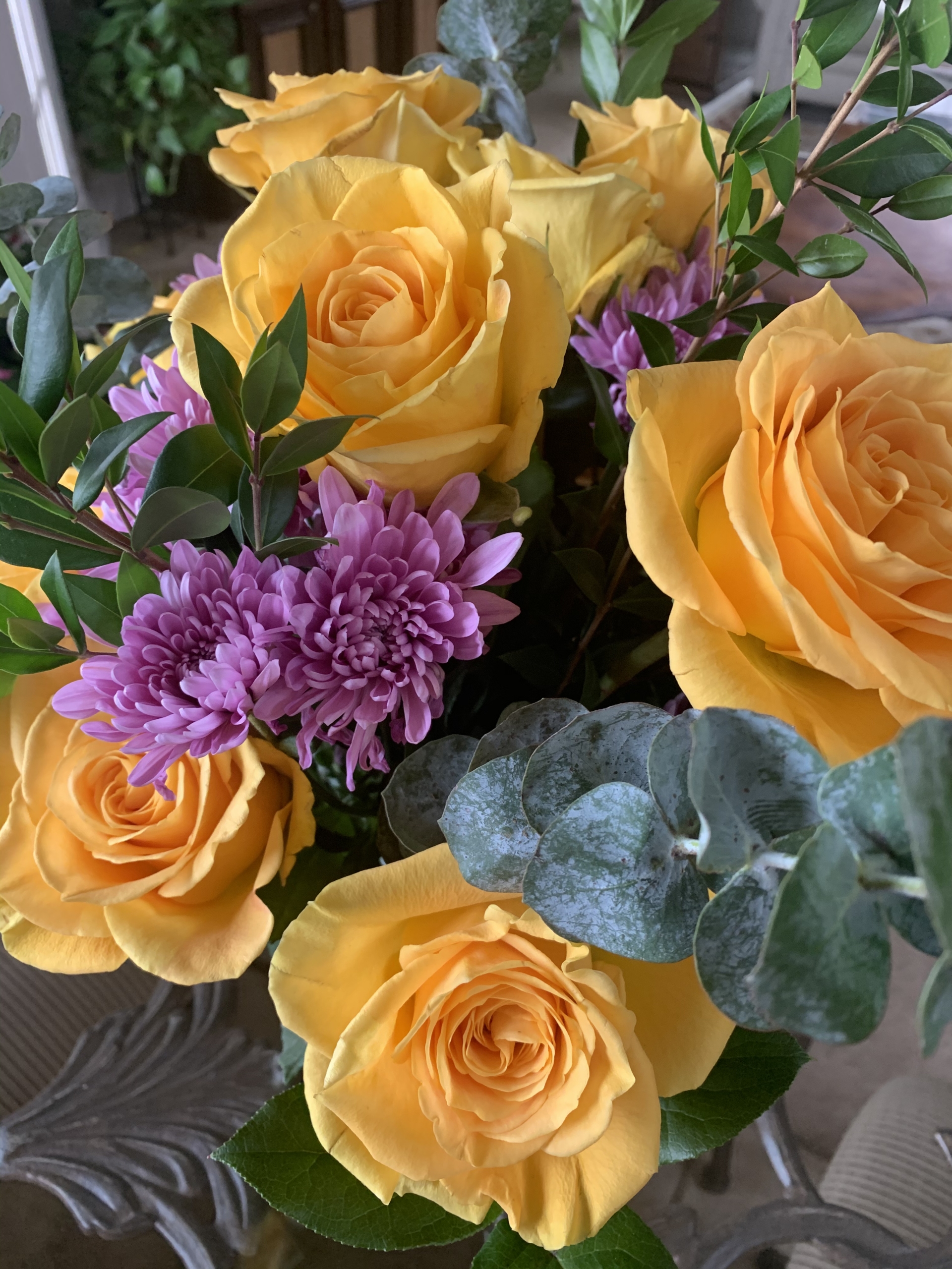 a forgiveness bouquet of yellow roses and assorted flowers