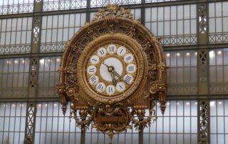 the large gold-colored clock in the Musee d'Orsay-defining moments