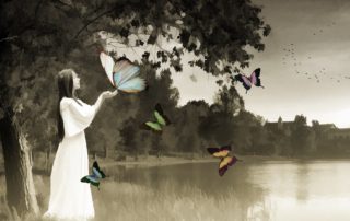 black and white photo with colorized butterflies landing on the hand of a young woman-wistful questions