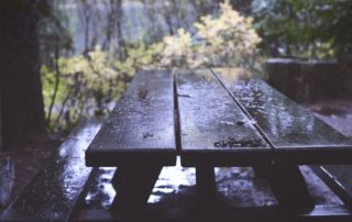 a wooden picnic table in the rain for living on the edge