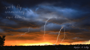 dark storm clouds with lightening and the setting sun visible on the horizon