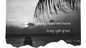 black and white photo of the setting sun over the ocean with a small boat in the left bottom and a palm frond reading over the scene in the upper right