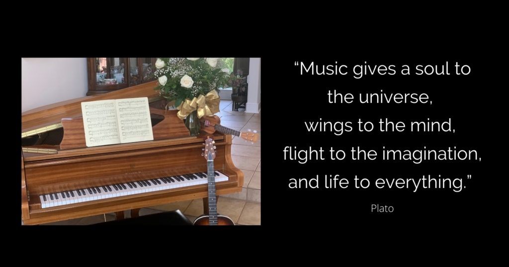 Upright piano with sheet music, flowers, and a guitar beside it, paired with Plato’s inspiring quote about music and imagination.